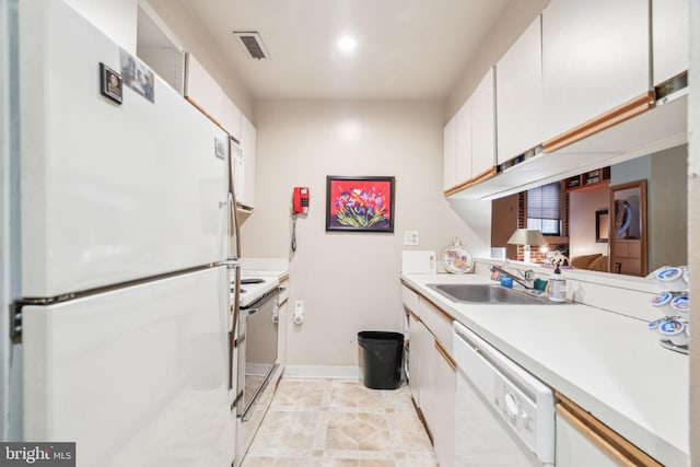 kitchen with white cabinetry, sink, and white appliances