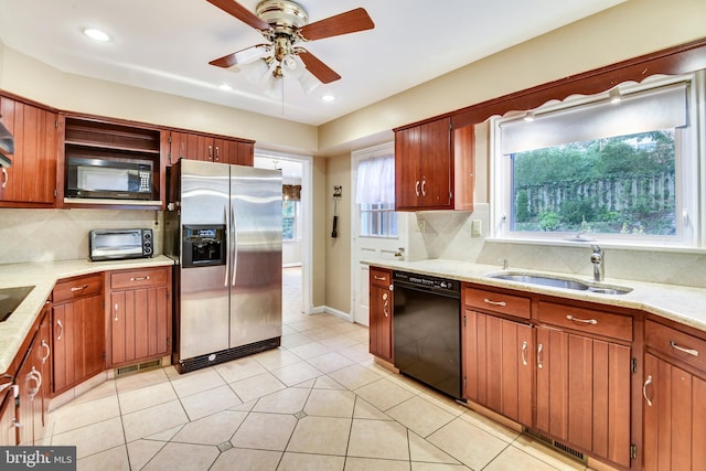 kitchen with tasteful backsplash, sink, light tile patterned floors, ceiling fan, and black appliances