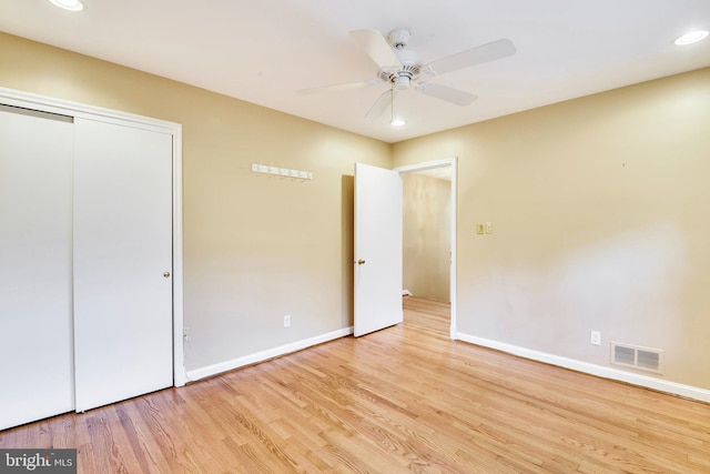 unfurnished bedroom featuring ceiling fan, a closet, and light hardwood / wood-style flooring