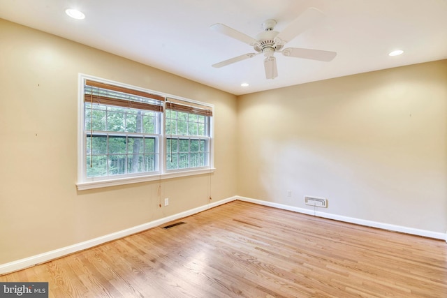 spare room featuring ceiling fan and light hardwood / wood-style flooring