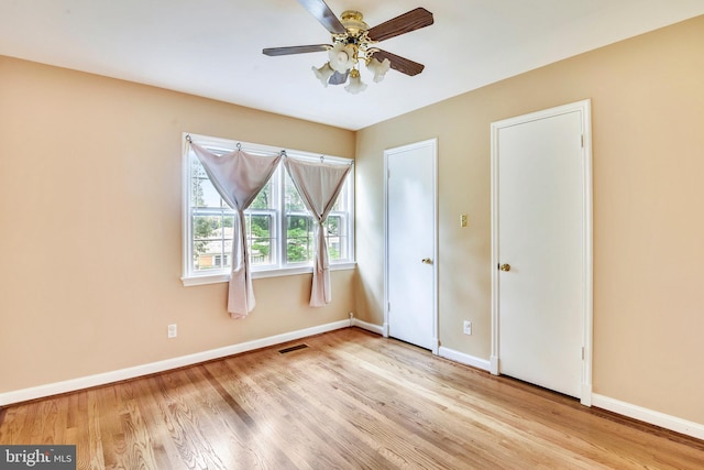 unfurnished bedroom with ceiling fan and light wood-type flooring