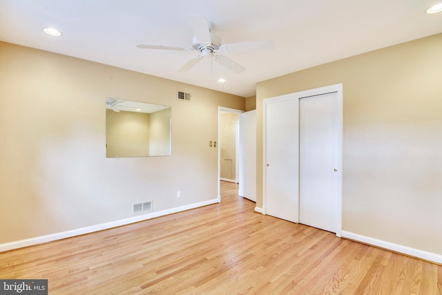 unfurnished bedroom with ceiling fan, light hardwood / wood-style floors, and a closet