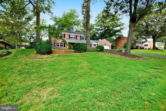 view of front of house with a garage and a front lawn