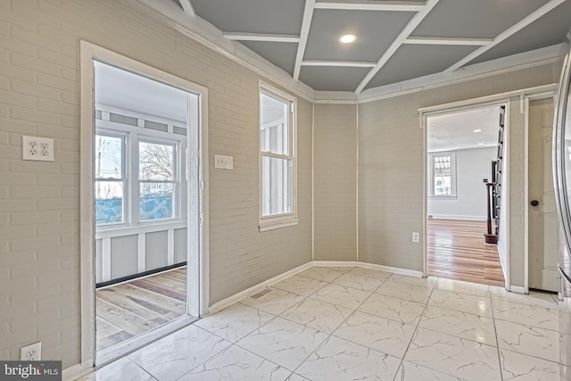 interior space featuring brick wall and plenty of natural light