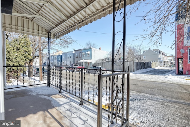 view of snow covered back of property