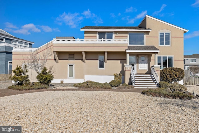 view of front of house featuring a balcony