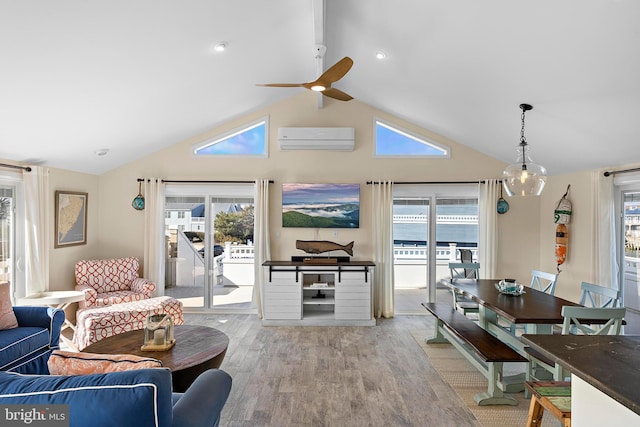 living room featuring a wealth of natural light, vaulted ceiling, a wall mounted AC, and light hardwood / wood-style floors