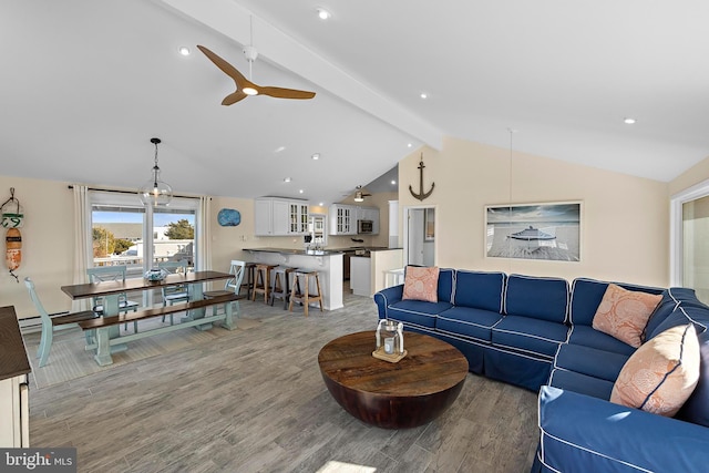 living room with wood-type flooring, vaulted ceiling with beams, and ceiling fan