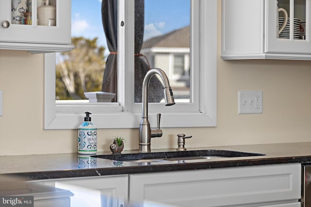 room details with white cabinetry and sink