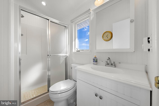 bathroom featuring vanity, toilet, and walk in shower