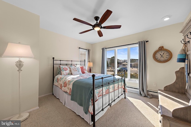 carpeted bedroom with a baseboard radiator and ceiling fan