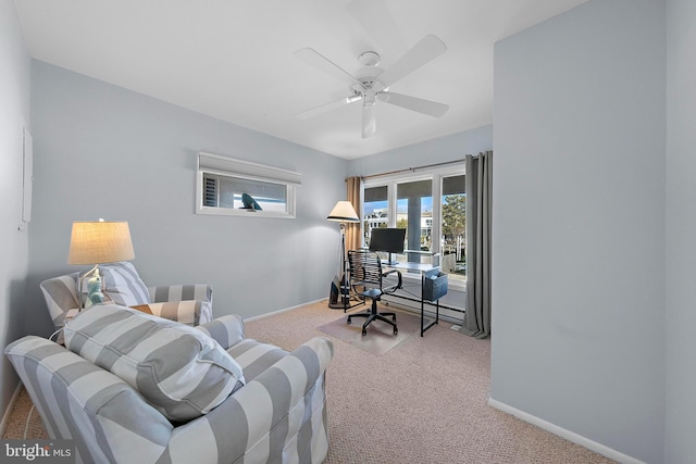 carpeted home office featuring ceiling fan