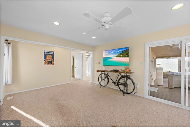 carpeted living room with ceiling fan