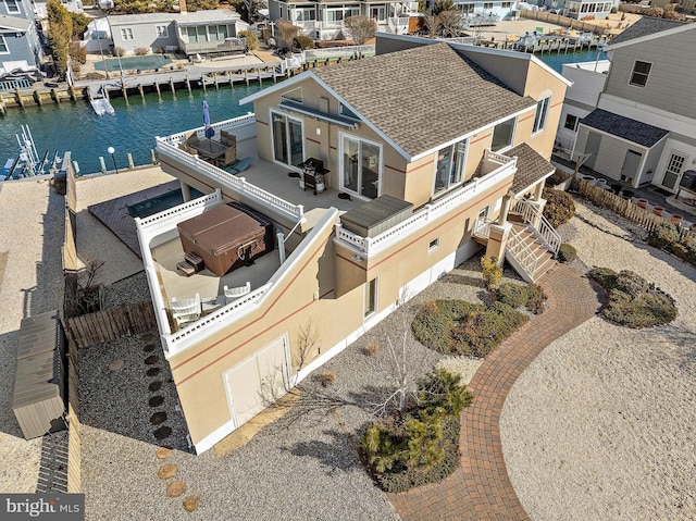 birds eye view of property with a water view