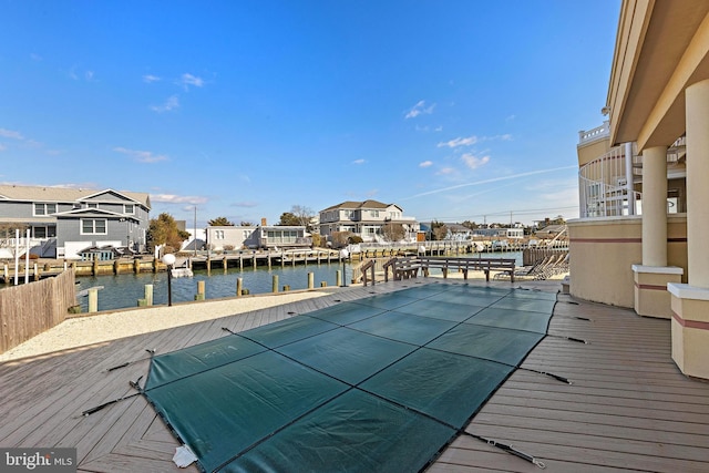 view of pool featuring a water view and a dock