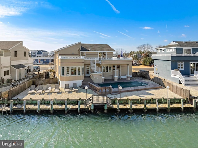 rear view of property featuring a patio and a water view