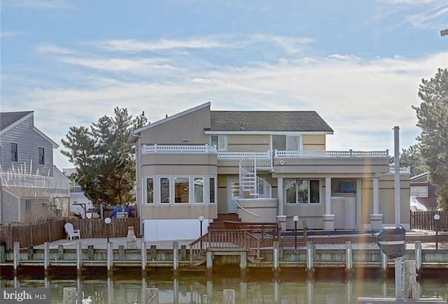 back of property with a water view