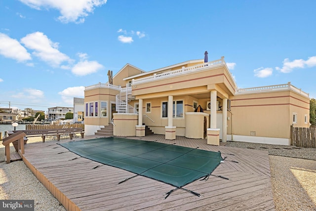 back of property with a pool side deck