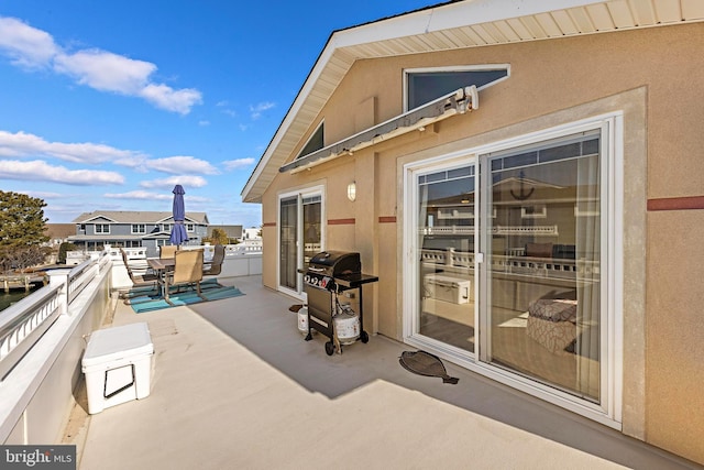 view of patio / terrace featuring a grill and a balcony