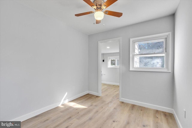 empty room with ceiling fan and light hardwood / wood-style floors