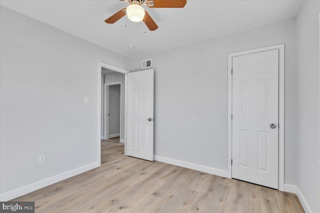 unfurnished bedroom with ceiling fan and light wood-type flooring