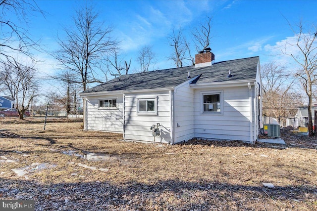 back of house with central AC unit