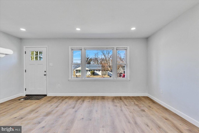 foyer entrance with plenty of natural light and light hardwood / wood-style floors