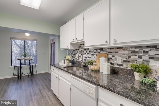 kitchen featuring sink, white cabinetry, tasteful backsplash, wood-type flooring, and dishwasher