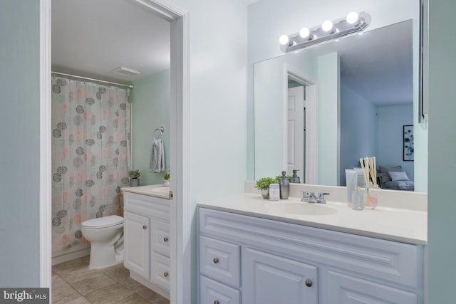 bathroom featuring vanity, toilet, and walk in shower