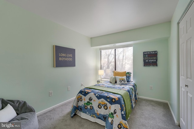 bedroom featuring light colored carpet and a closet