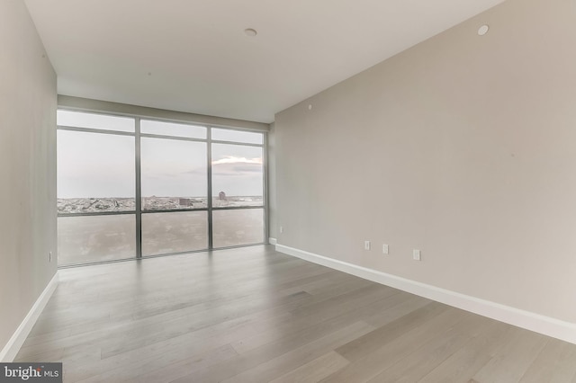 empty room with light hardwood / wood-style floors