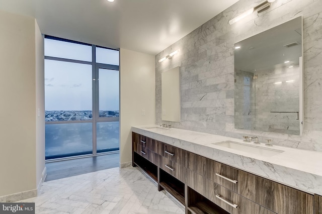 bathroom featuring vanity, floor to ceiling windows, and tile walls