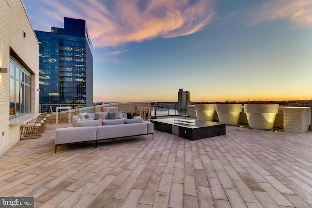 patio terrace at dusk featuring outdoor lounge area