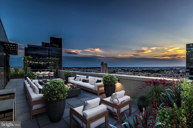 patio terrace at dusk featuring an outdoor hangout area