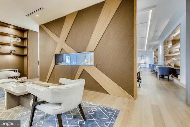 dining area with light hardwood / wood-style flooring and built in shelves