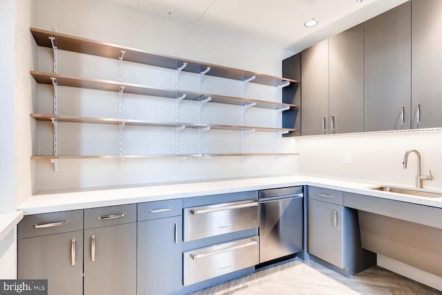 kitchen featuring sink and gray cabinetry