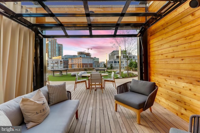 deck at dusk featuring outdoor lounge area