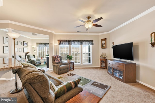 living room with ornamental molding, carpet, and ceiling fan