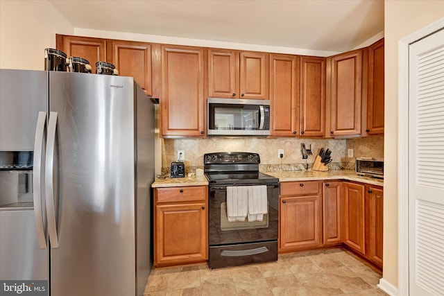 kitchen with tasteful backsplash, stainless steel appliances, and light stone counters