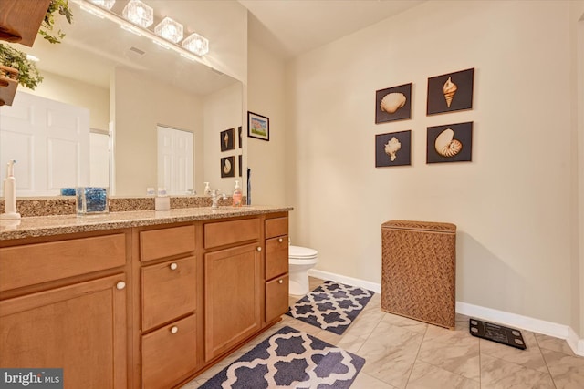 bathroom featuring vanity and toilet