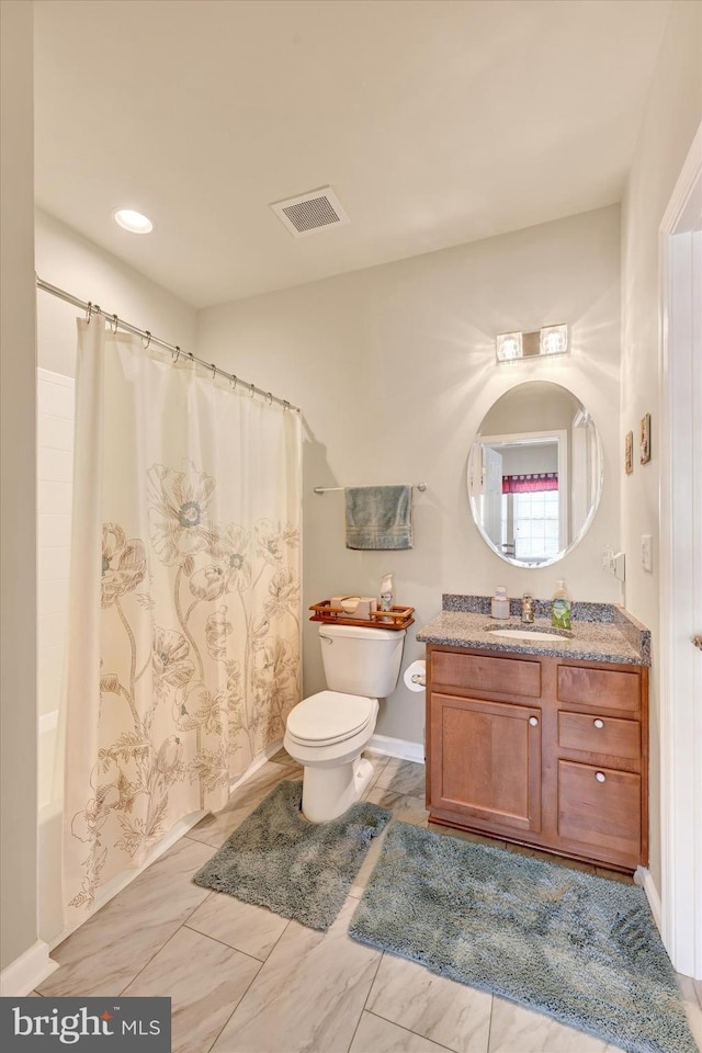 full bathroom featuring vanity, shower / bath combo, and toilet