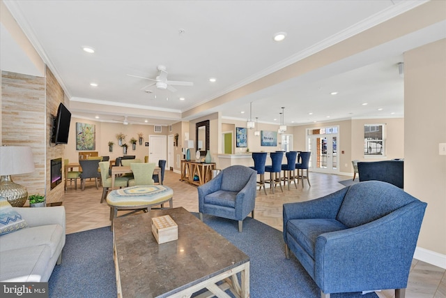 living room with ornamental molding, parquet floors, ceiling fan, and a fireplace