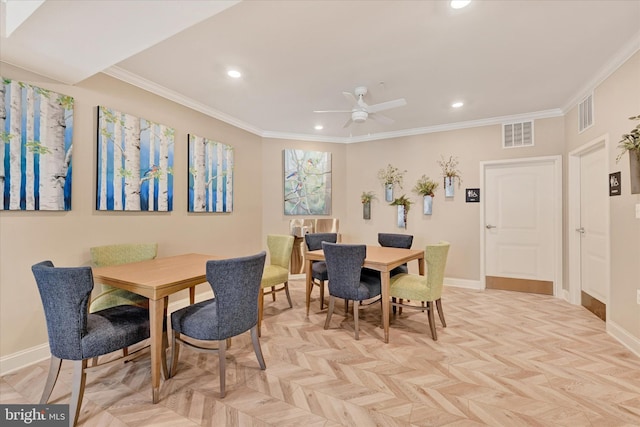 dining space with crown molding, ceiling fan, and light parquet floors