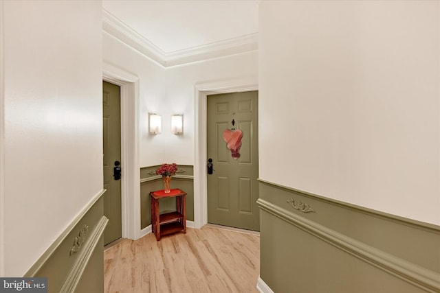 corridor featuring light hardwood / wood-style flooring and ornamental molding