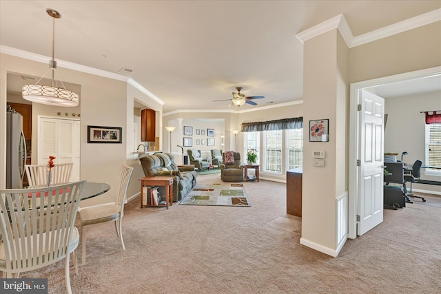 living room featuring light carpet, ornamental molding, and ceiling fan