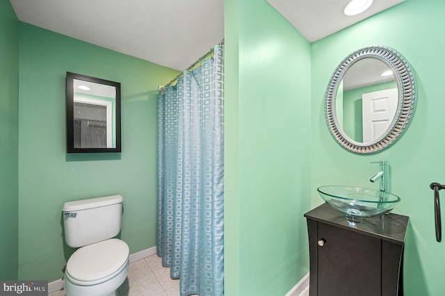 bathroom with walk in shower, vanity, tile patterned floors, and toilet