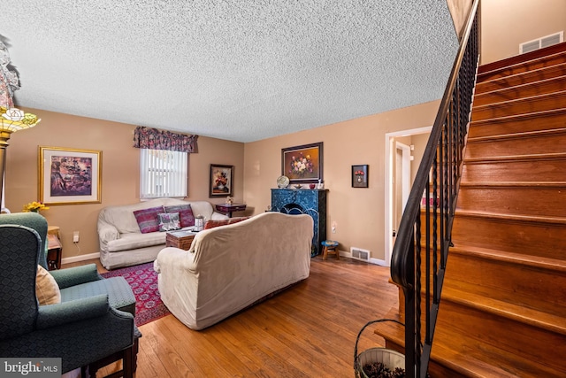 living room featuring hardwood / wood-style flooring and a textured ceiling