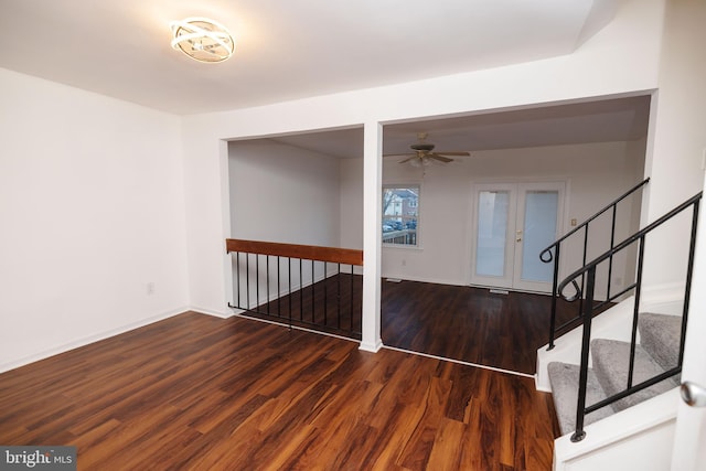 interior space with dark wood-type flooring and ceiling fan