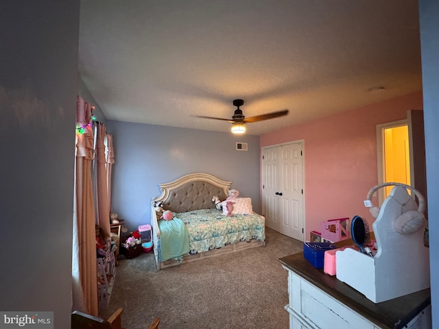 bedroom featuring a closet, ceiling fan, and carpet