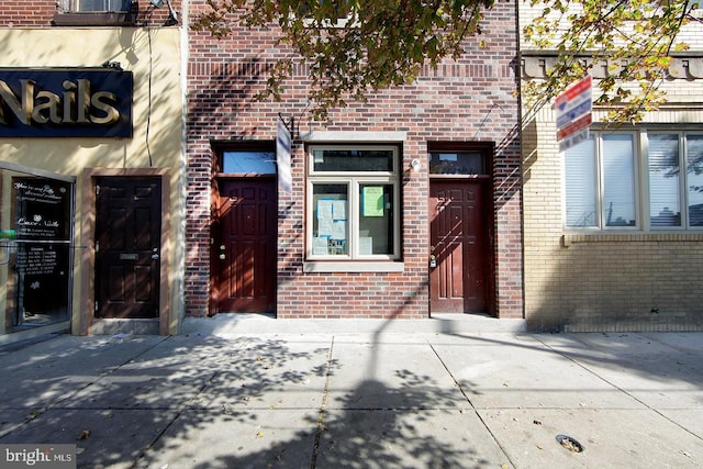 property entrance featuring brick siding